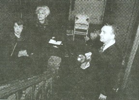Marian Despres and others retrrieve a banister from a structure about to be demolished in urban renewal.