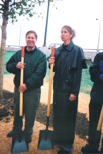 Gary Ossewaarde of JPAC an Lauren Moltz of Friends of Parks prepare to throw dirt to dedicate a tree west of LSD at 57th