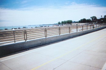 On the east bike trail over the underpass-sleek railings, bleak unfinished work at  lakeshore