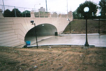 Looking at high-classic lined face of 59th underpass from southeast