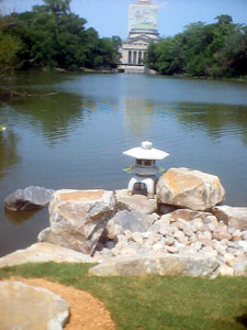 Similar to left but spotlighting stone lantern and piled-up rocks. Osaka Garden