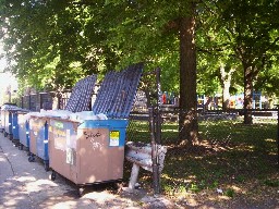 Problem-causing dumpsters encroaching  north end of park. (Incidently, open dumpsters are  illegal).